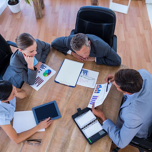 Multiple people going through a chart together