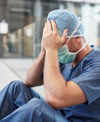 doctor frustrated and holding head.