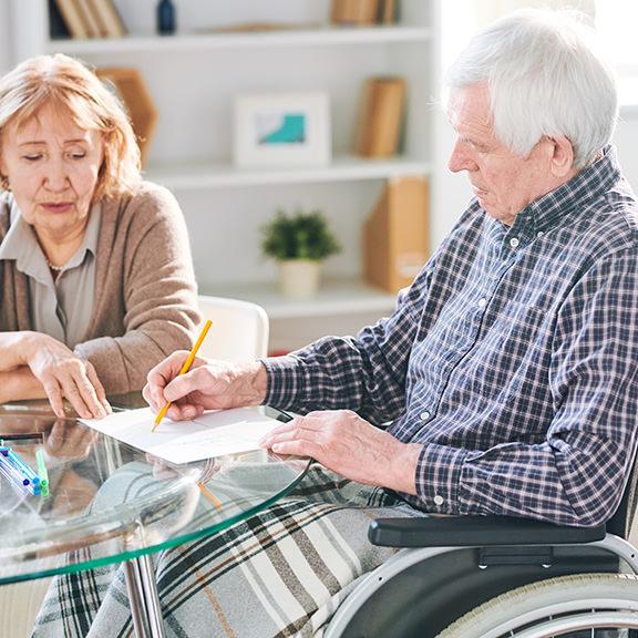 Two elderly people looking at papers