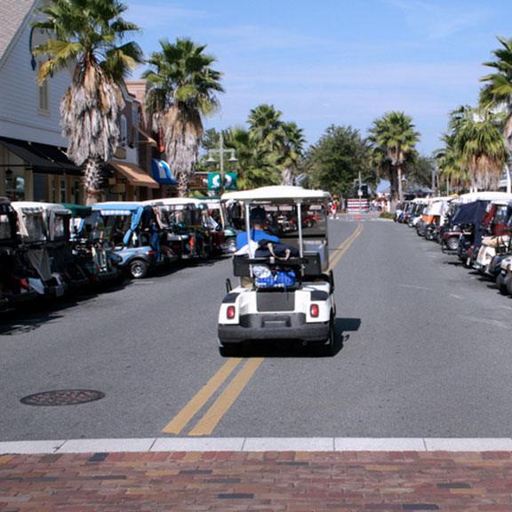 Golf cart riding on the road Golf cart riding on the road
