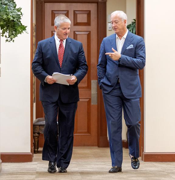 Mark and Lance walking down a hallway