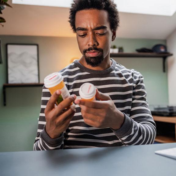 African-American man in doubt what medicine to take