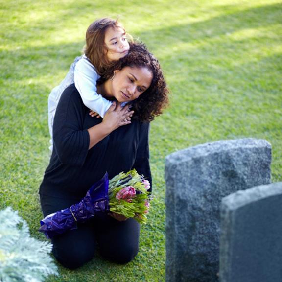 Family mourning on a graveyard