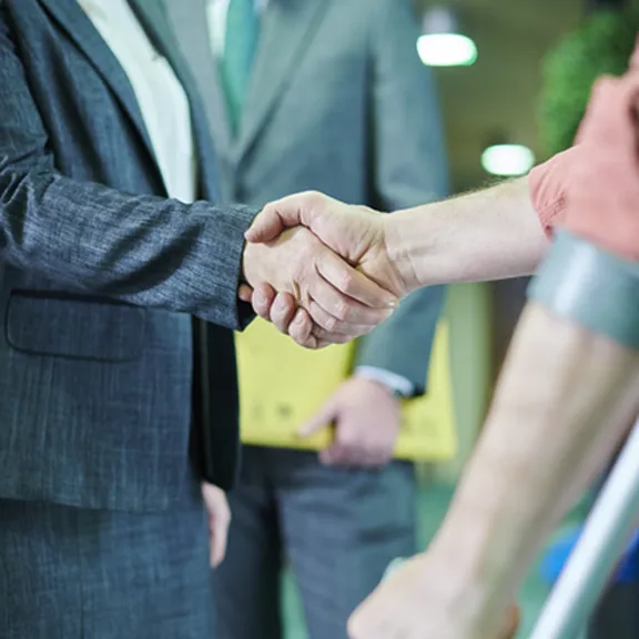 attorney shaking worker's hand